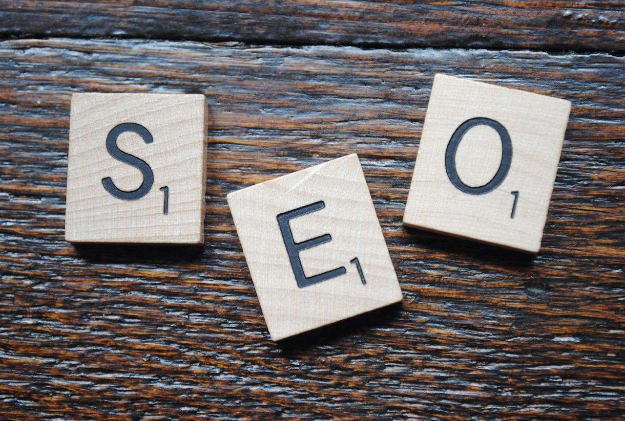 services-01 Close-up of Scrabble tiles spelling SEO on a wooden table for content strategy.