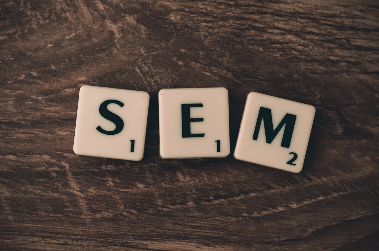 services-02 Wooden background with letter tiles spelling SEM, representing search engine marketing.